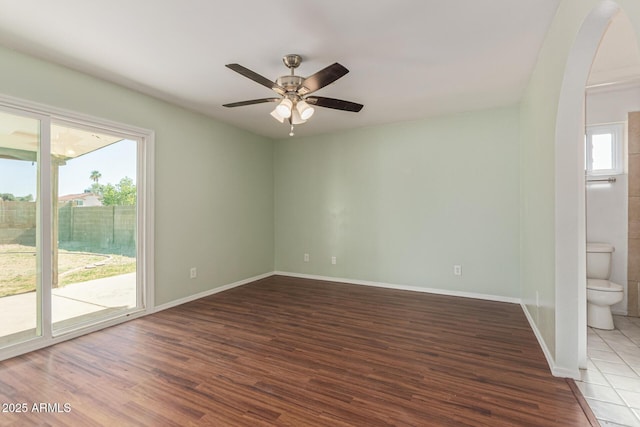 4845 W Evans Dr, Glendale, AZ 85306 - spare room featuring arched walkways, wood finished floors, and a ceiling fan
