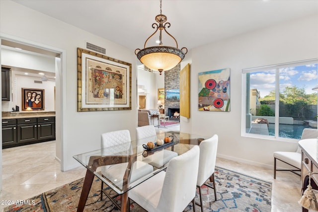 dining space with a stone fireplace