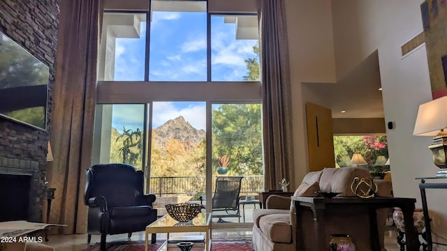 interior space featuring a mountain view, a fireplace, and a high ceiling