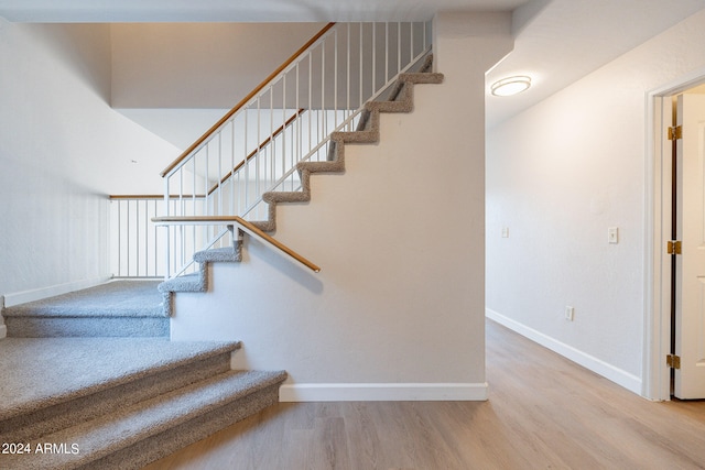 stairs with wood-type flooring