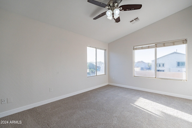 carpeted empty room with ceiling fan and lofted ceiling