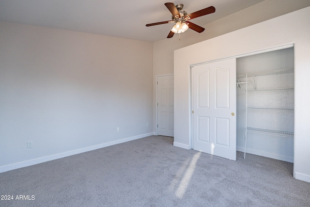 unfurnished bedroom with a closet, carpet, and ceiling fan