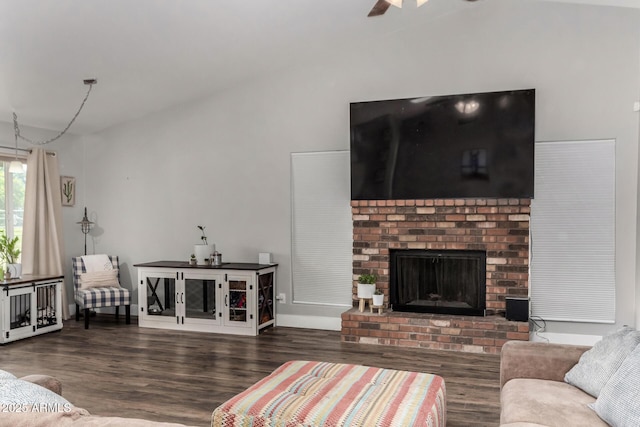 living area featuring a brick fireplace, wood finished floors, and a ceiling fan