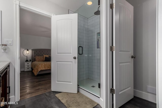 ensuite bathroom with tile patterned floors, ensuite bathroom, and a stall shower