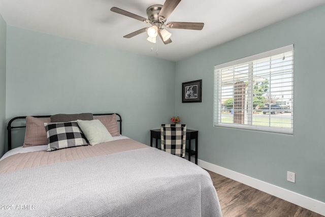 bedroom featuring baseboards, a ceiling fan, and wood finished floors