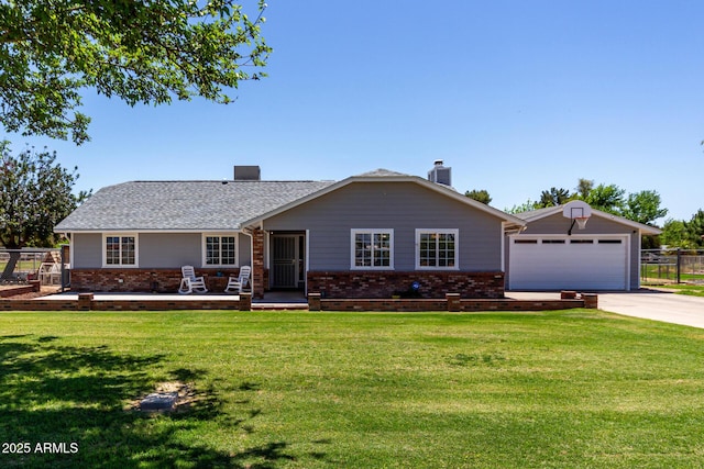 ranch-style house with a front lawn, brick siding, an outbuilding, and driveway