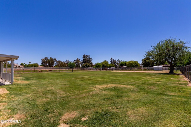 view of yard featuring fence and a rural view