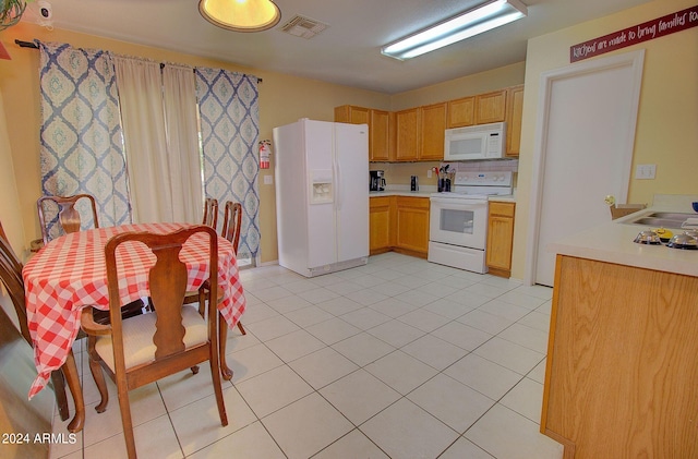 kitchen with light tile patterned flooring, sink, tasteful backsplash, and white appliances