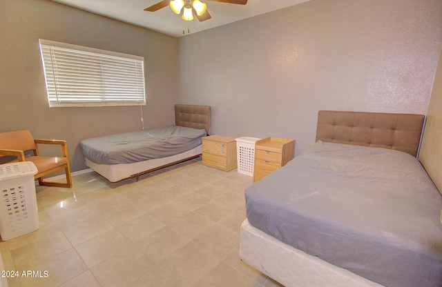 bedroom with tile patterned flooring and ceiling fan