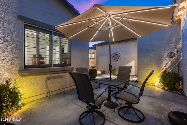 view of patio terrace at dusk