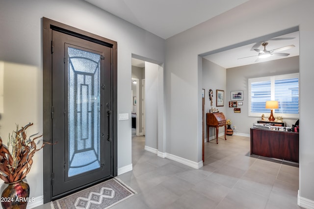 entryway with ceiling fan and light tile patterned floors