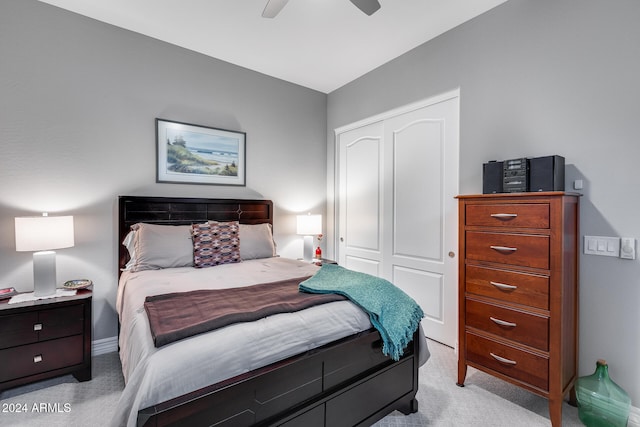 carpeted bedroom with ceiling fan, a closet, and lofted ceiling