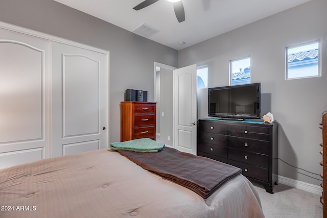 carpeted bedroom featuring a closet and ceiling fan