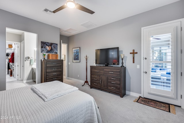 bedroom with access to exterior, ceiling fan, light colored carpet, a walk in closet, and a closet