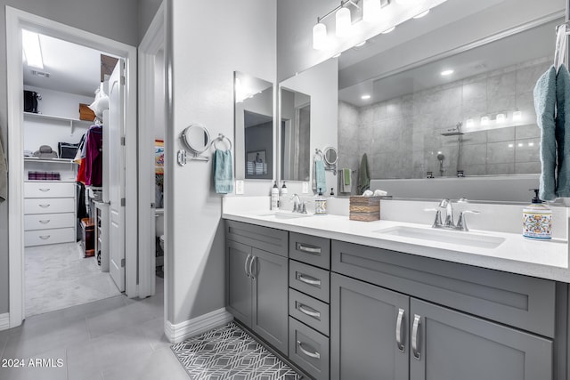 bathroom featuring tile patterned floors, vanity, and tiled shower