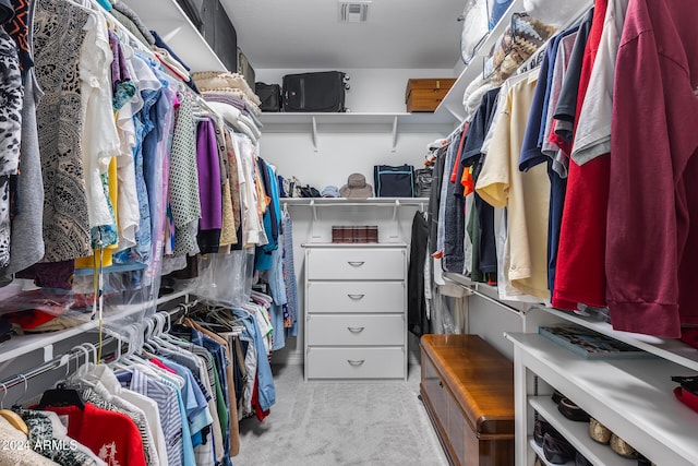 walk in closet featuring light carpet