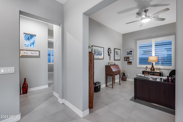 tiled office featuring ceiling fan