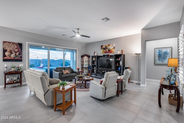 tiled living room featuring ceiling fan