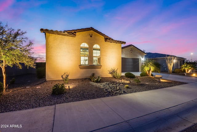 mediterranean / spanish-style home featuring a garage