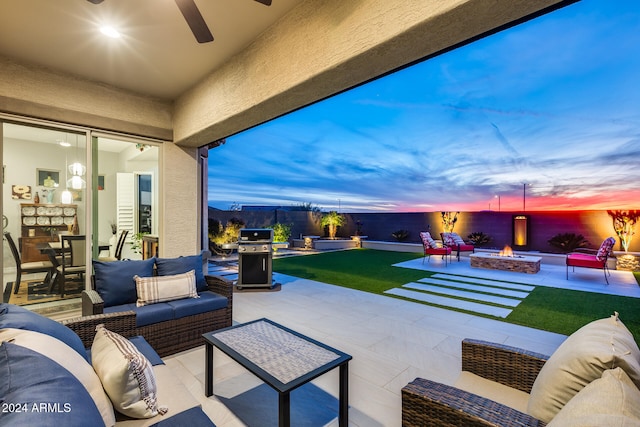 patio terrace at dusk with a grill, ceiling fan, and an outdoor living space with a fire pit