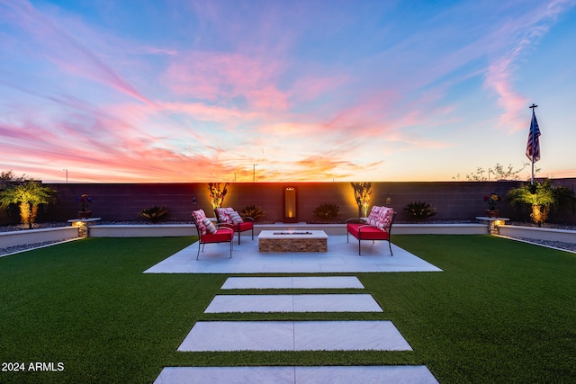 yard at dusk with a patio area