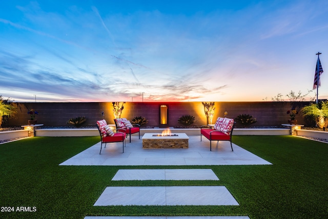 yard at dusk with a patio and an outdoor fire pit