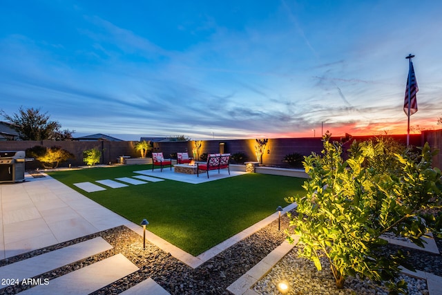 yard at dusk with a patio area and an outdoor living space with a fire pit