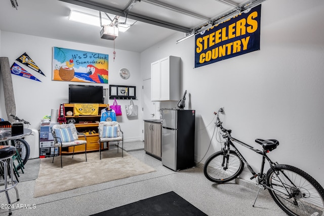 interior space with a garage door opener and stainless steel refrigerator