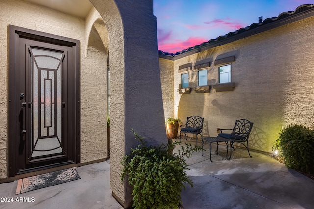 view of exterior entry at dusk