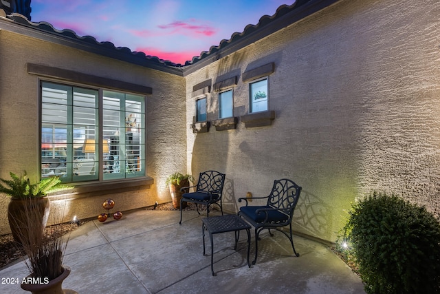 view of patio terrace at dusk