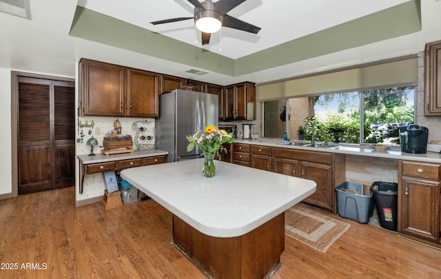 1298 E Buffalo St, Chandler, AZ 85225 - kitchen with a sink, freestanding refrigerator, light countertops, a ceiling fan, and light wood finished floors