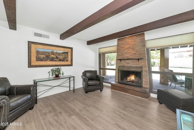 1298 E Buffalo St, Chandler, AZ 85225 - living area featuring light wood finished floors, beam ceiling, and a large fireplace