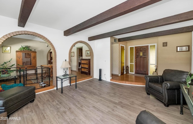 1298 E Buffalo St, Chandler, AZ 85225 - living room with light wood-type flooring, arched walkways, beam ceiling, and baseboards