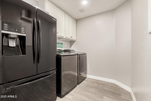 laundry room with visible vents, baseboards, light wood-style floors, cabinet space, and independent washer and dryer