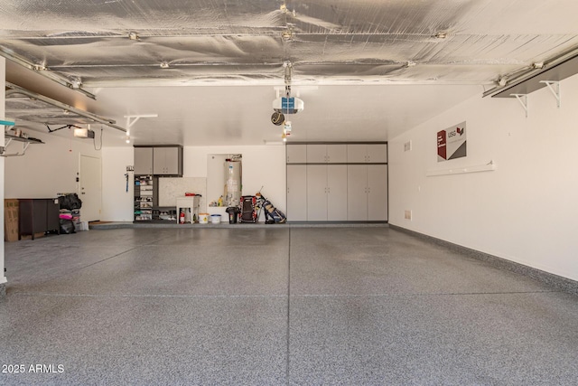garage with baseboards, a garage door opener, and water heater