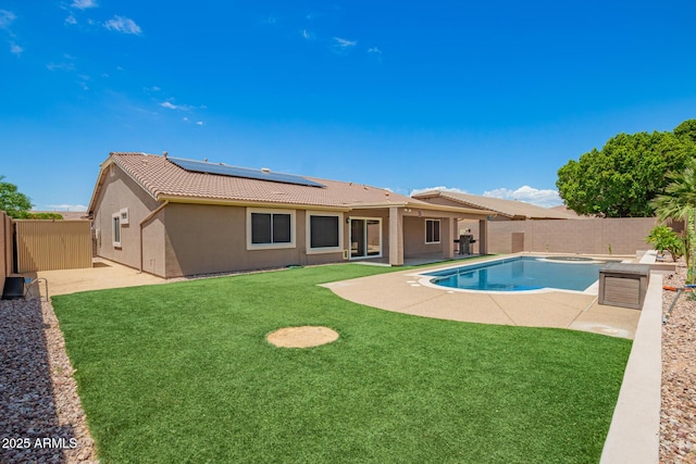 view of pool featuring a fenced backyard, a fenced in pool, a yard, and a patio area