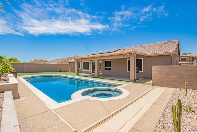 view of pool with ceiling fan, an in ground hot tub, a patio area, a fenced in pool, and a fenced backyard