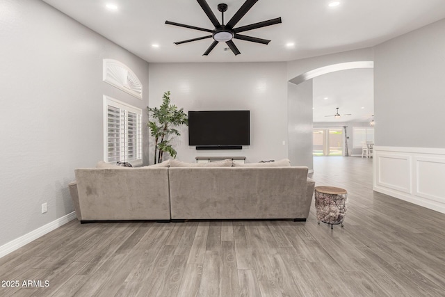 living room with recessed lighting, a ceiling fan, arched walkways, and wood finished floors