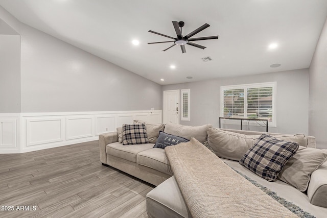 living area featuring visible vents, ceiling fan, recessed lighting, a wainscoted wall, and light wood finished floors