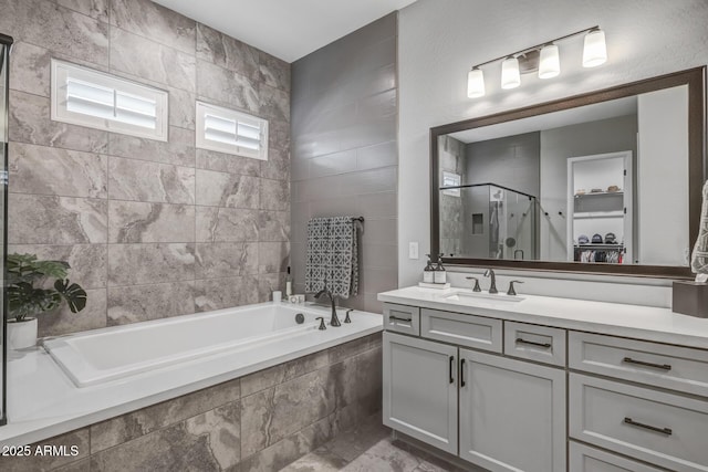 bathroom with vanity and independent shower and bath