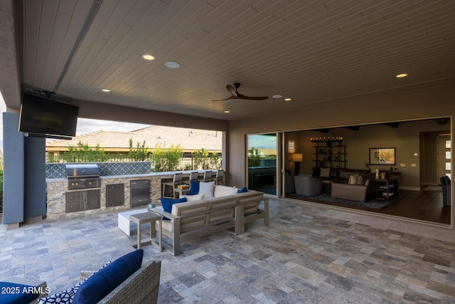 view of patio with exterior kitchen, outdoor lounge area, area for grilling, and ceiling fan