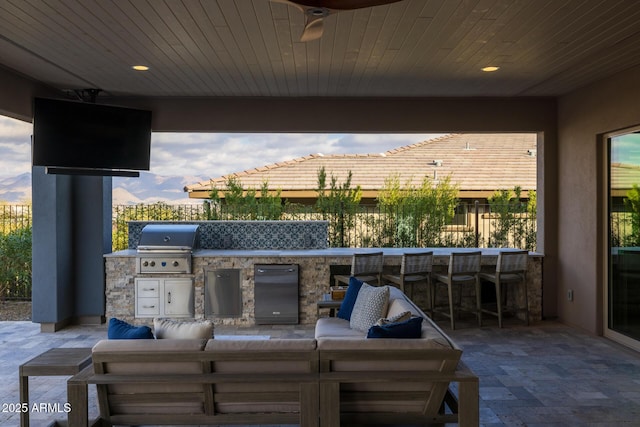 view of patio / terrace featuring area for grilling, a grill, an outdoor hangout area, an outdoor bar, and ceiling fan