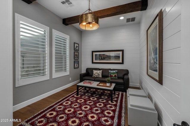 living room with wood-type flooring and beam ceiling