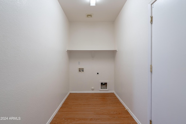 laundry area with laundry area, light wood-style floors, hookup for a washing machine, gas dryer hookup, and electric dryer hookup