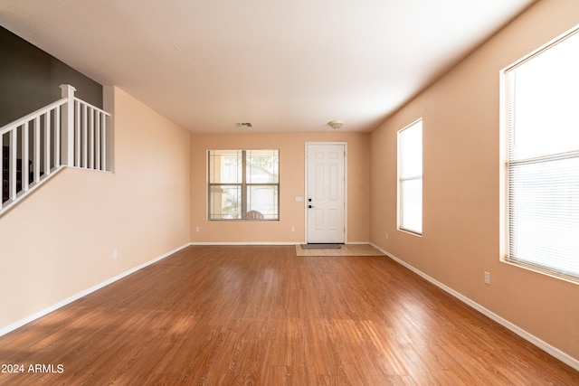 unfurnished living room featuring light wood-style floors and baseboards