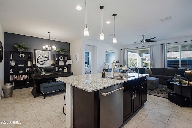 kitchen featuring a center island with sink, open floor plan, a sink, dishwasher, and ceiling fan with notable chandelier