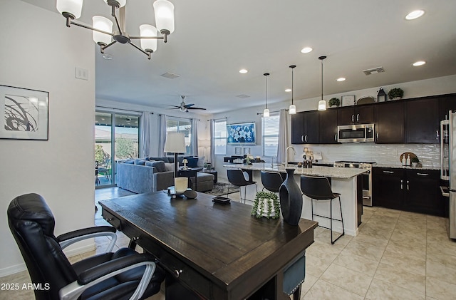 home office with ceiling fan with notable chandelier, light tile patterned flooring, visible vents, and recessed lighting