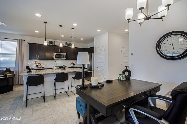 interior space featuring recessed lighting, visible vents, a sink, and light tile patterned flooring