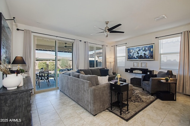 living room featuring a ceiling fan, a wealth of natural light, and visible vents