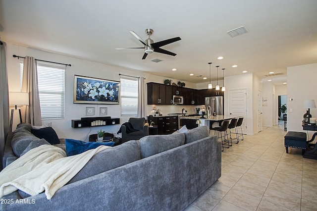 living area with recessed lighting, visible vents, ceiling fan, and light tile patterned floors